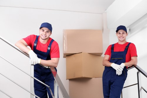 Local moving team handling stairs in a Belsizepark property