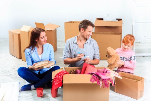 Professional movers handling furniture near a period property in Belsize Park