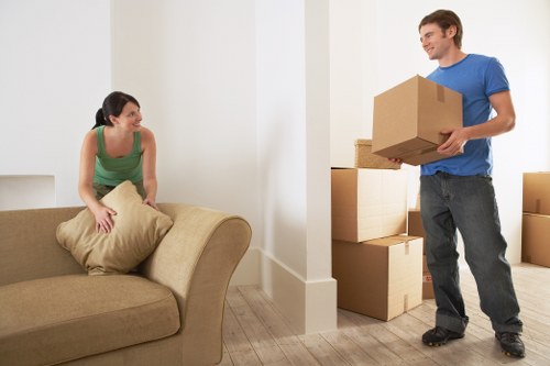 Team separating cardboard, wood, and metals for recycling during a local move